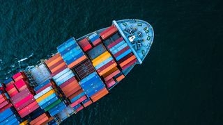 An aerial overhead view of the front half of a container ship