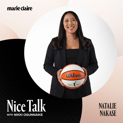 a press shot of natalie nakase holding a basketball and wearing a black suit