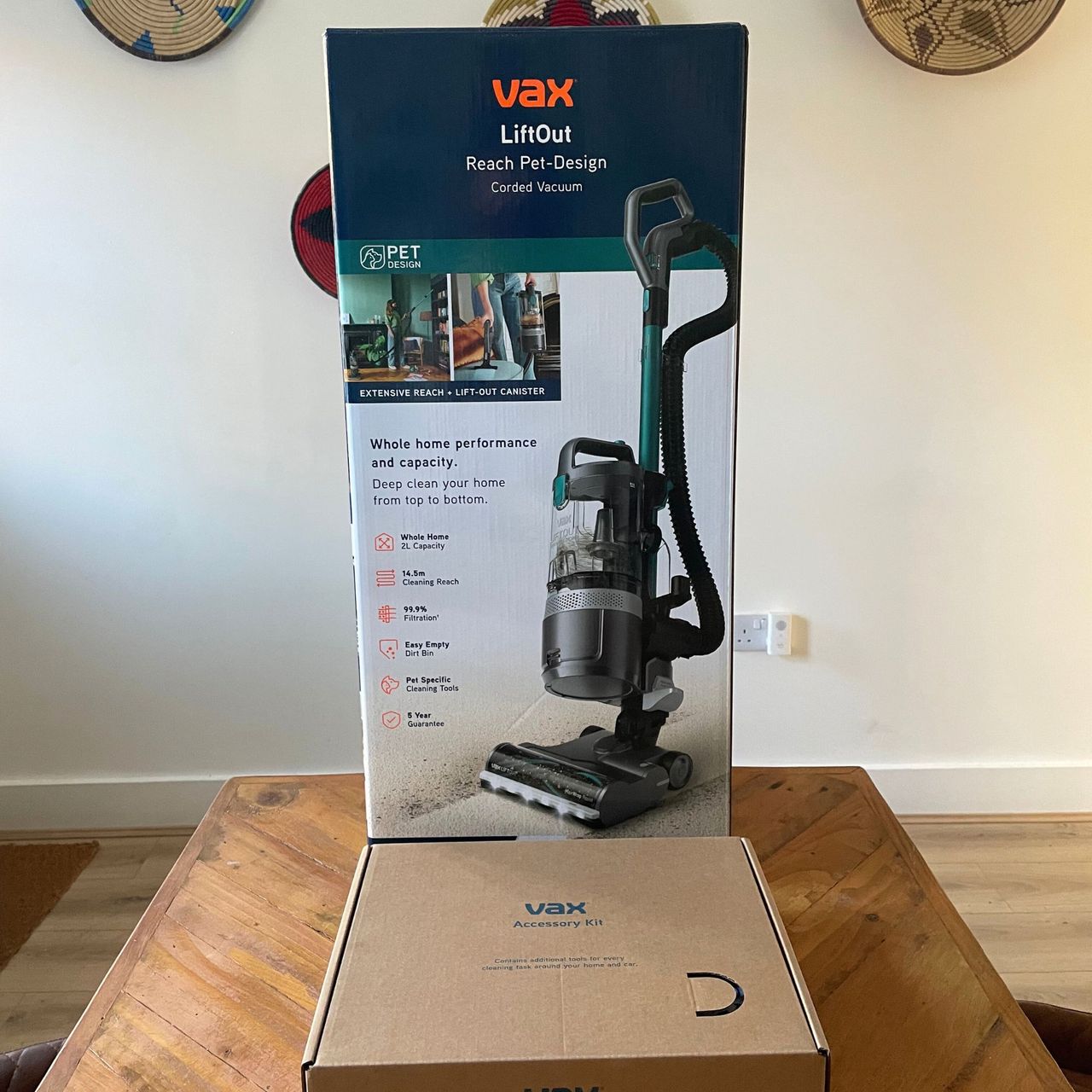 Vax LiftOut Reach Pet Design Vacuum Cleaner boxes sitting on a wooden table