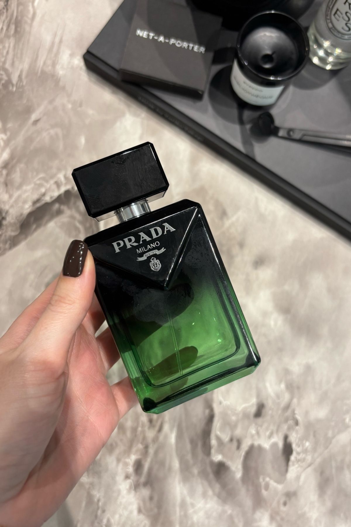 Deputy beauty editor Grace Lindsay holding a bottle of Prada Paradigme