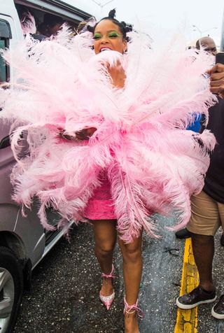 Rihanna is spotted during “Kadooment Day” parade late Monday in St. Michael Parish, Barbados. 2019 pink feathered dress