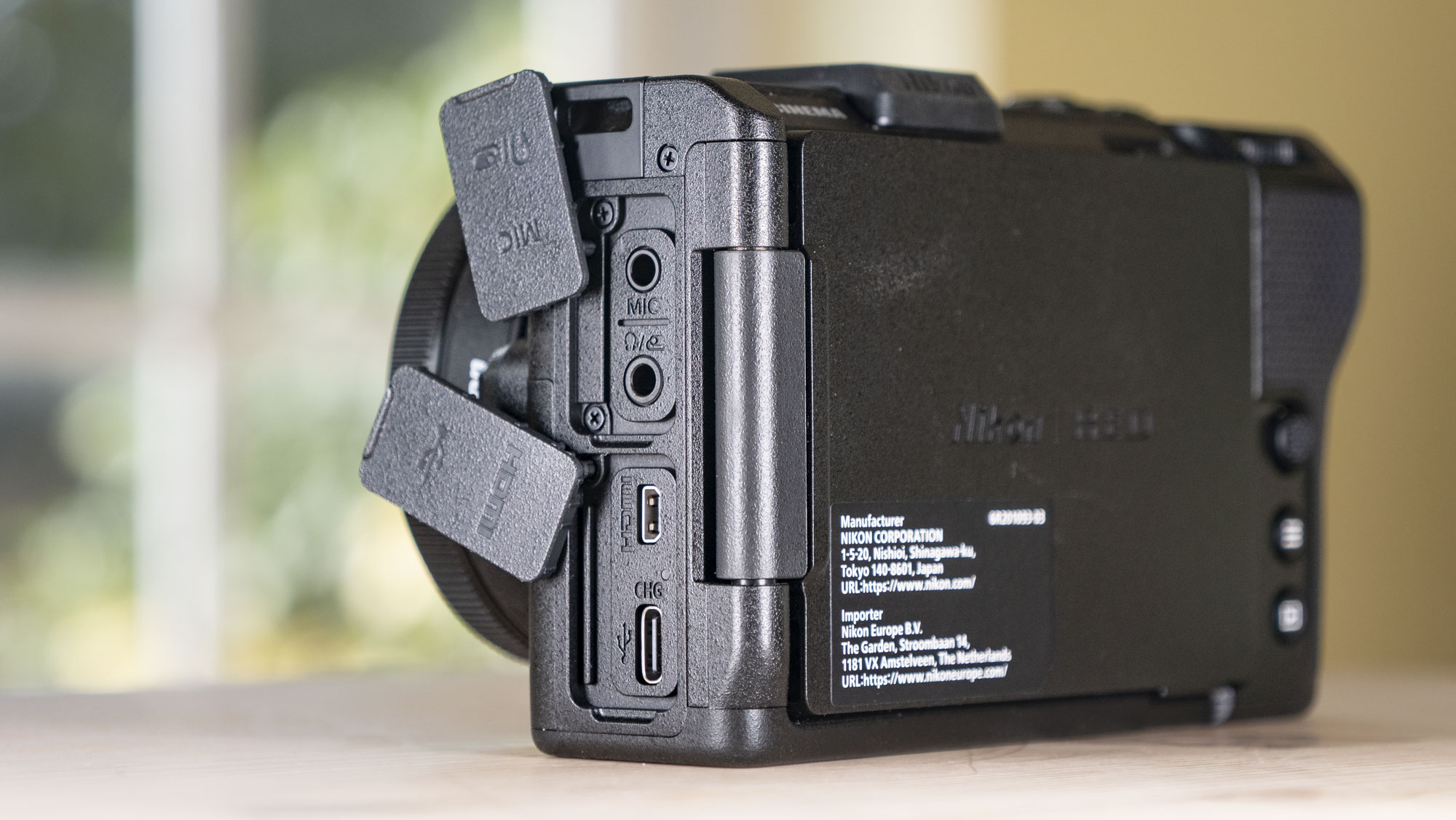 Nikon ZR product photos – camera on a wooden table, port doors open