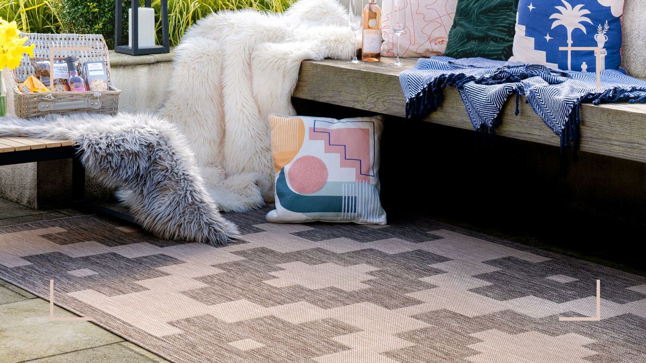 Outdoor patio area with bench seating and outdoor furnishings to support how to clean an outdoor rug