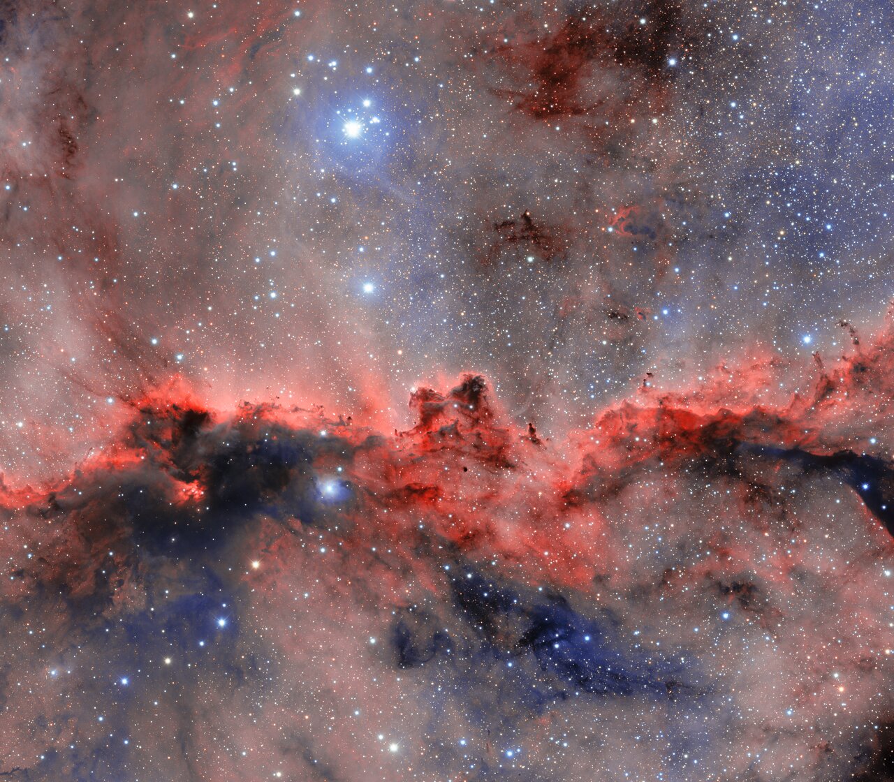 an image of a nebula with a red horizontal cloud that resembles two dragons
