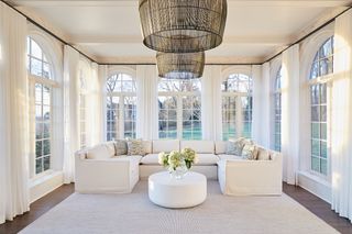 all white sunroom with large white sectional