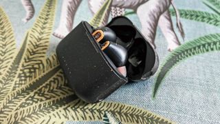 House of Marley Redemption ANC 2 review: headphones in their charging case on green leafy background