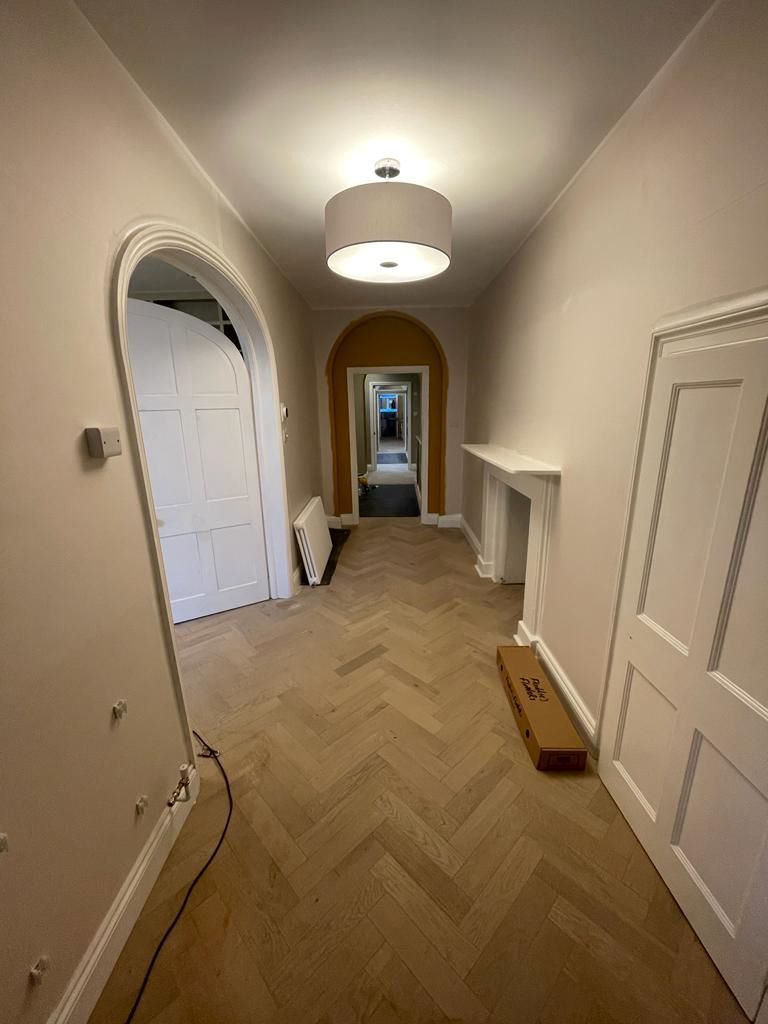 The hallway during the renovation with herringbone wooden floor being built