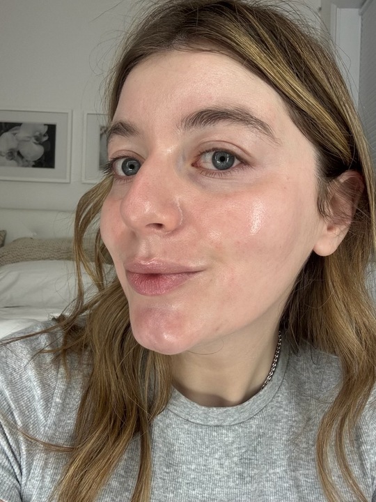 a girl with a gray shirt and blonde hair after applying spf.