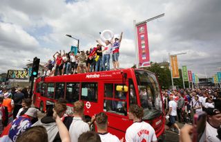 England fans climb aboard a bus outside the ground several hours before kick off