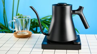 the all-black matte fellow stagg ekg kettle with an electric base and customizable temperature and a gooseneck spout, perfect for pour-over coffees