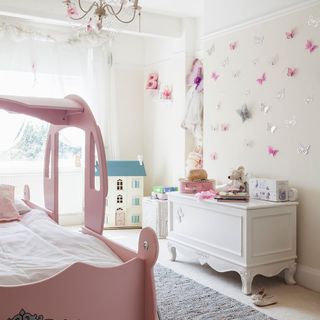 pink children's bedroom with pink wall and bed