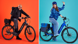 Two people on Raleigh Motus e-bikes. On the left with an orange background is a bald man with brown skin, smiling at the camera and holding the handlebars. On the right, with a blue background is a white woman wearing a helmet, with one hand raised, and looking off the the side