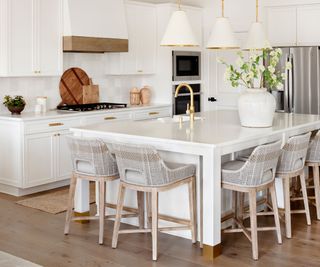 A white kitchen decorated with wood decor for spring