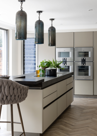 Sleek modern kitchen with two double ovens at standing height