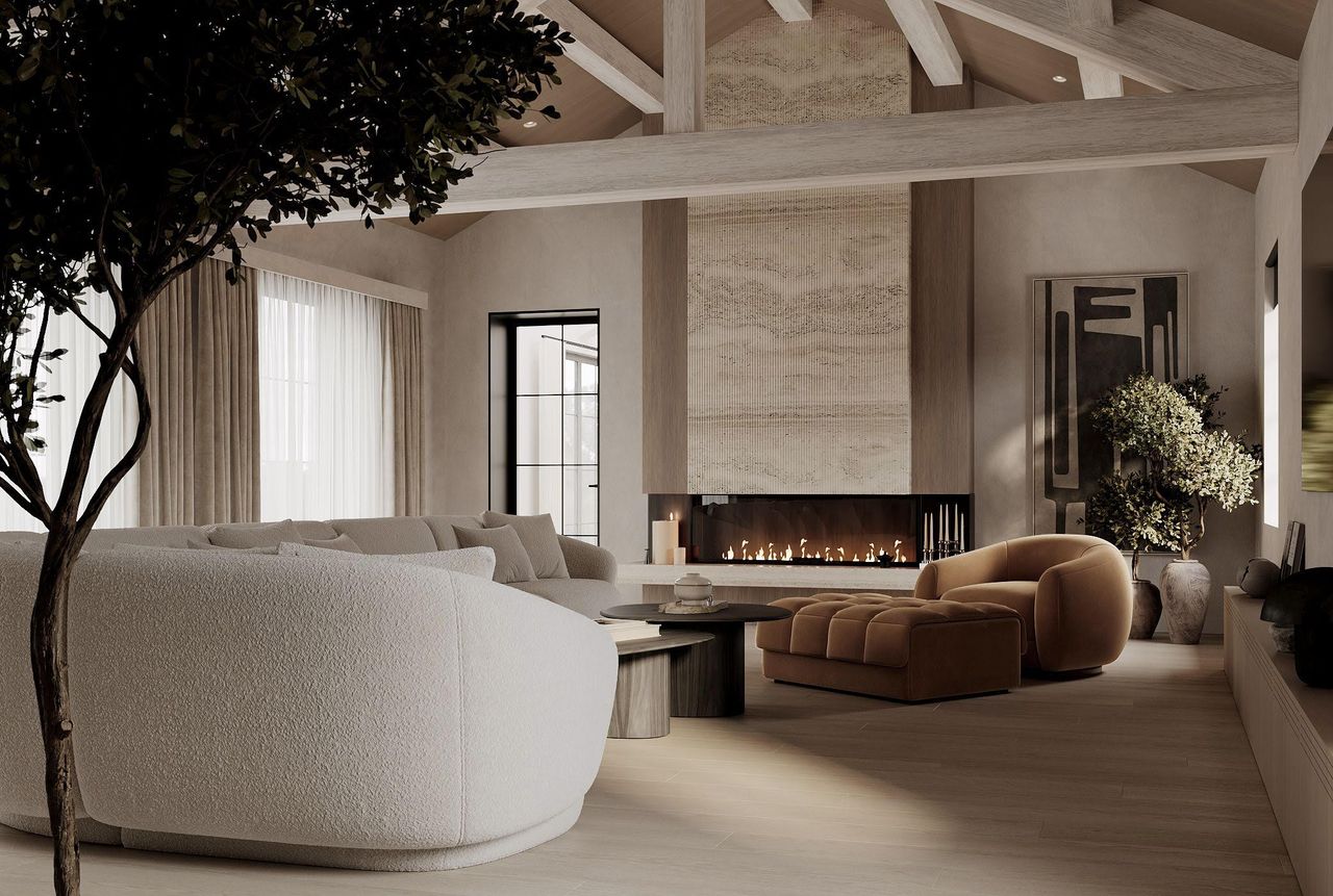 grand living room with curved sofas and a fire