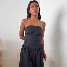 Monikh wearing black strapless dress