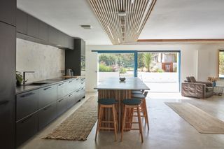 black kitchen with timber ceiling cladding