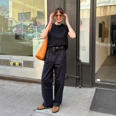 Influencer wears suede fisherman sandals.