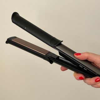 Laura holding Remington ONE Straight & Curl Styler - best hair straighteners