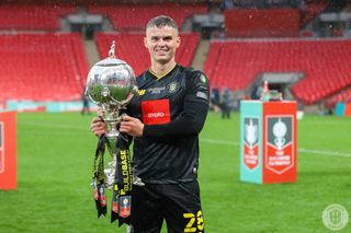 Josh McPake lifts the FA Trophy at Wembley