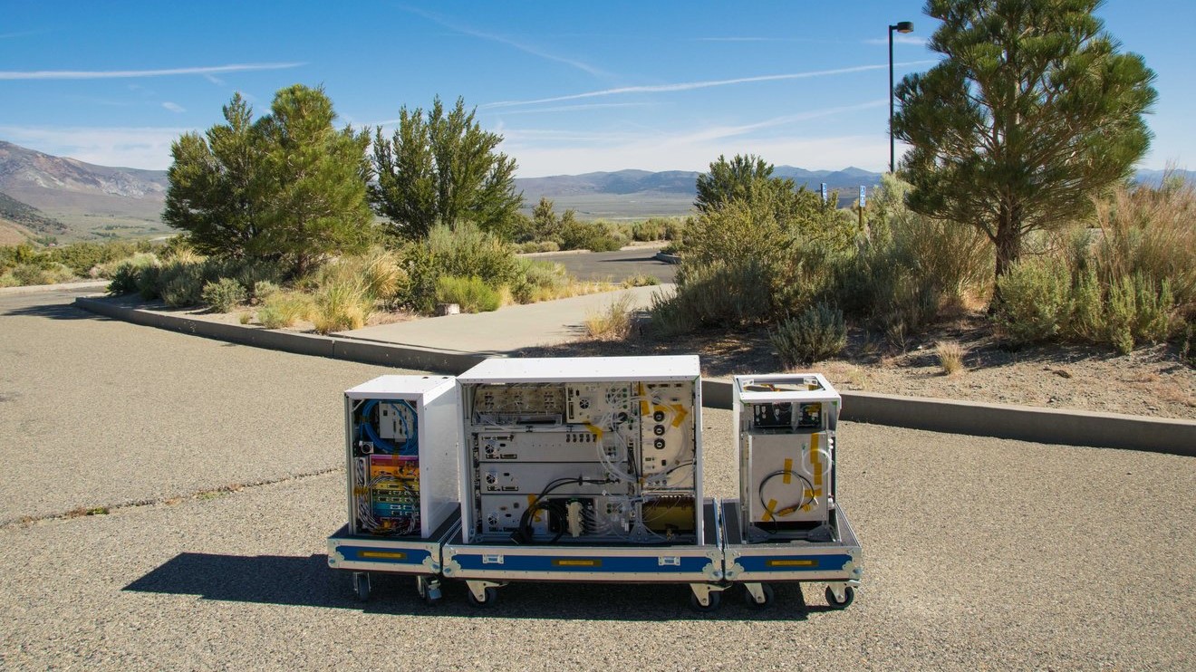 three electronics boxes on wheels on an empty street in California