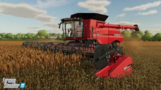 A red combine harvester works the fields