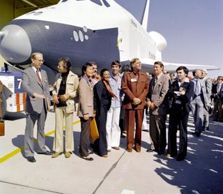 In 1976, NASA's space shuttle Enterprise rolled out of its manufacturing facility and was greeted by NASA officials and cast members from the "Star Trek" television series. From left to right: NASA Administrator James Fletcher; DeForest Kelley, who played Dr. "Bones" McCoy on the series; George Takei (Mr. Sulu); James Doohan (Chief Engineer Montgomery "Scotty" Scott); Nichelle Nichols (Lt. Uhura); Leonard Nimoy (Mr. Spock); series creator Gene Roddenberry; U.S. Rep. Don Fuqua (D-Fla.); and Walter Koenig (Ensign Pavel Chekov).