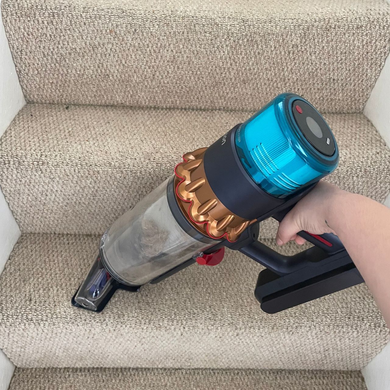 Using the handheld section of the Dyson Gen5Detect vacuum to vacuum stairs