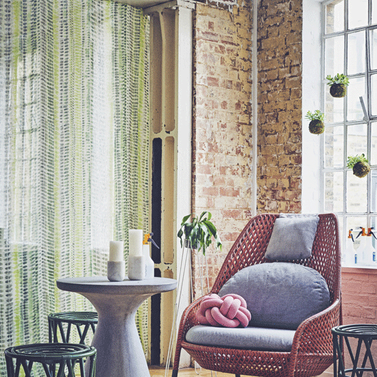 brick wall with chair and curtains