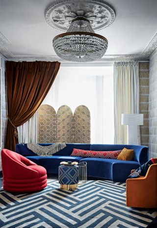 Living room with orange velvet curtain and blue sofa