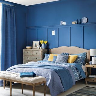 bedroom with blue walls and curtains