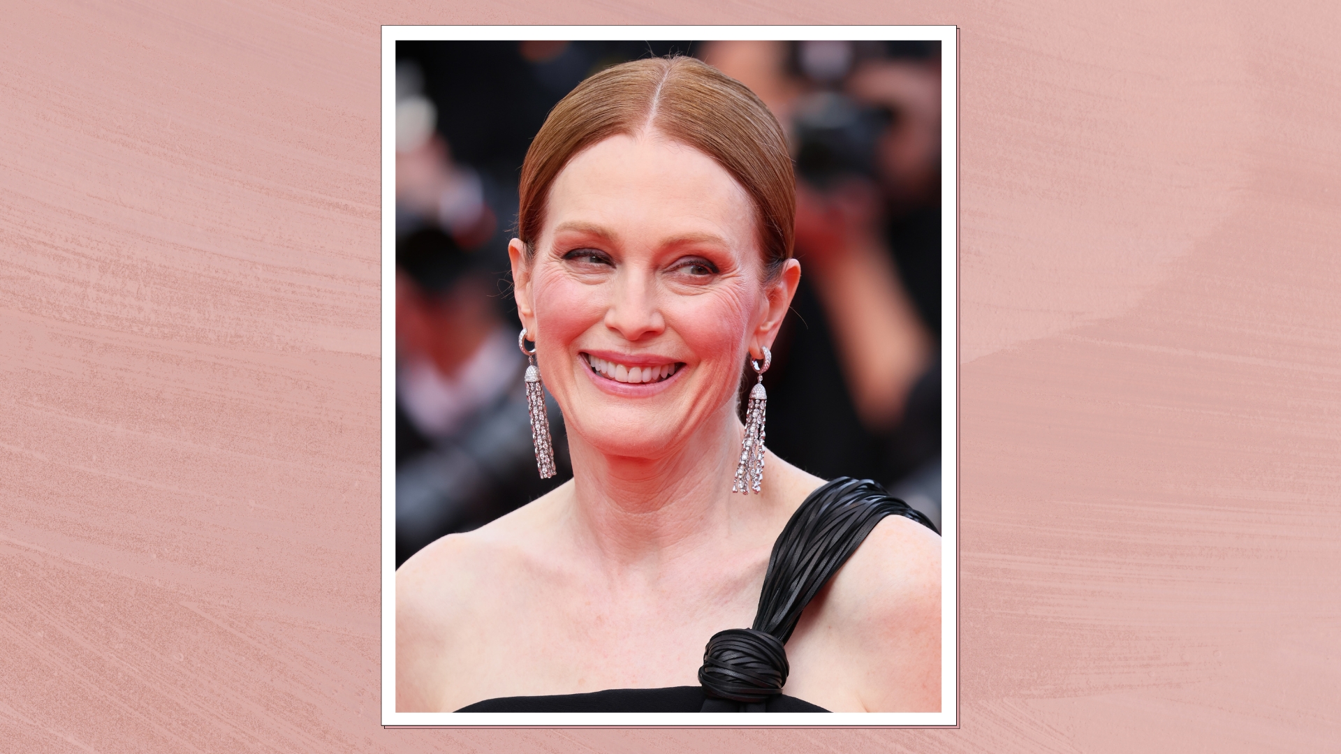 Julianne Moore is pictured with a sleek updo and wearing a black, one-shoulder dress at the "The Phoenician Scheme" red carpet at the 78th annual Cannes Film Festival at Palais des Festivals on May 18, 2025 in Cannes, France/ in a pink watercolour paint-style template