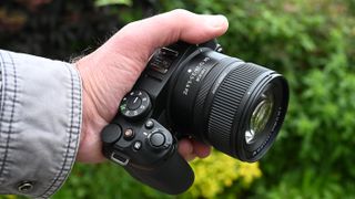 Nikon Z DX 12-28mm f/3.5-5.6 PZ VR on a camera held in a hand outside