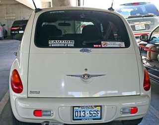 Wardriving vehicle. This PT cruiser had several antennas and interesting bumper stickers. License plate frame reads,