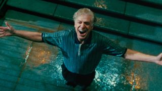 Shooter McGavin (Christopher McDonald) smiles in the rain in Happy Gilmore 2