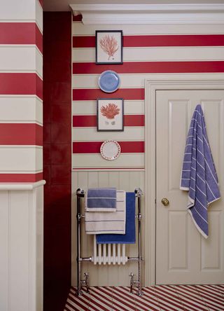 A bold red stripe wallpaper in a bathroom