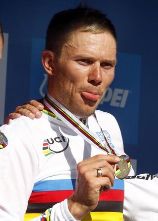 Thor Hushovd (Norway) shows some tongue while holding his new gold medal.