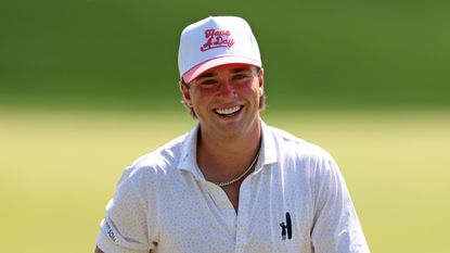 Michael La Sasso smiles while wearing a 'Have A Day' cap at the 2025 3M Open