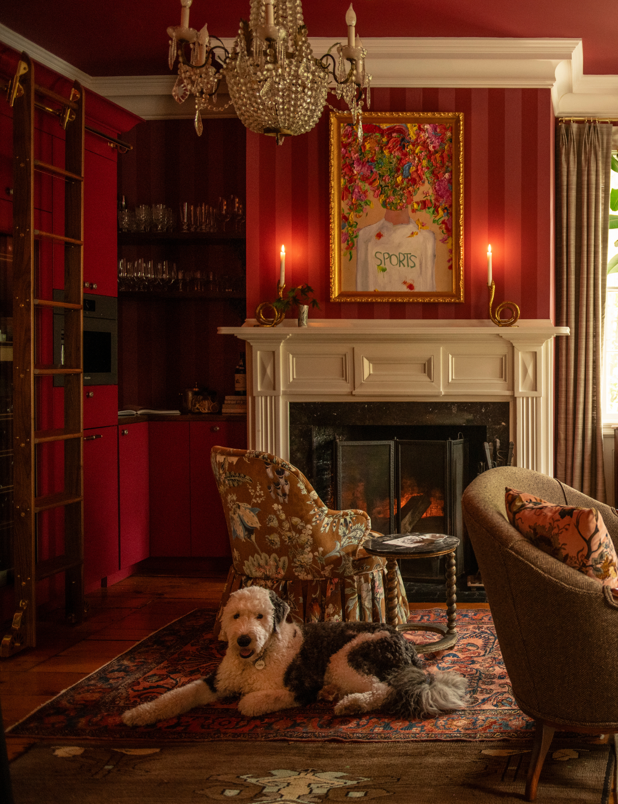 Pink-and-red striped sitting rom featuring antique furniture and a dog