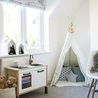 childrens room with soft toys white walls and wooden vanity