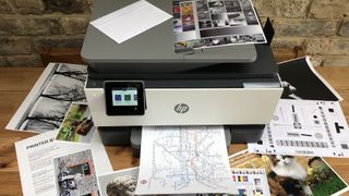 HP OfficeJet Pro 9015e/9010e surrounded by print-outs