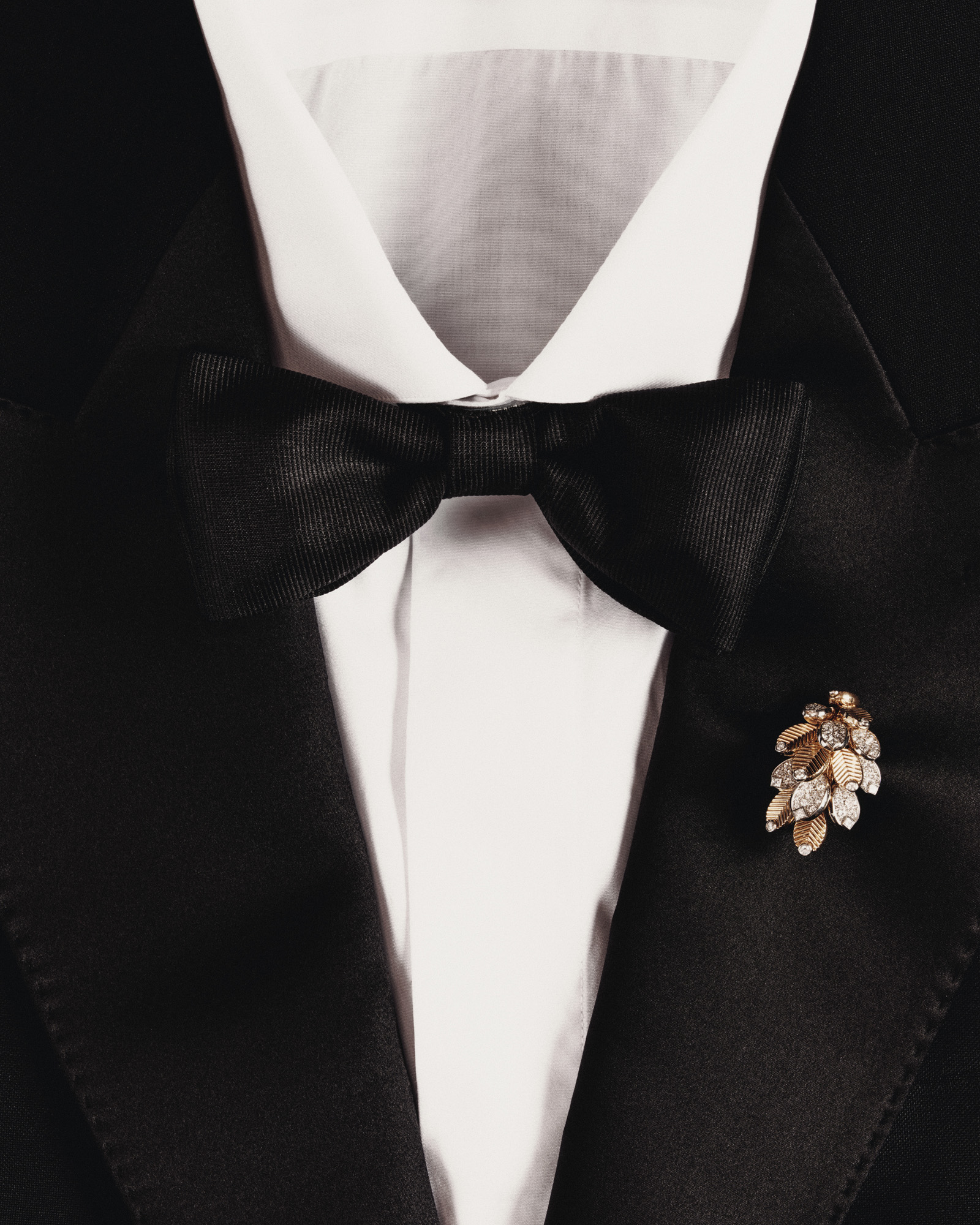 cartier brooch on black tie