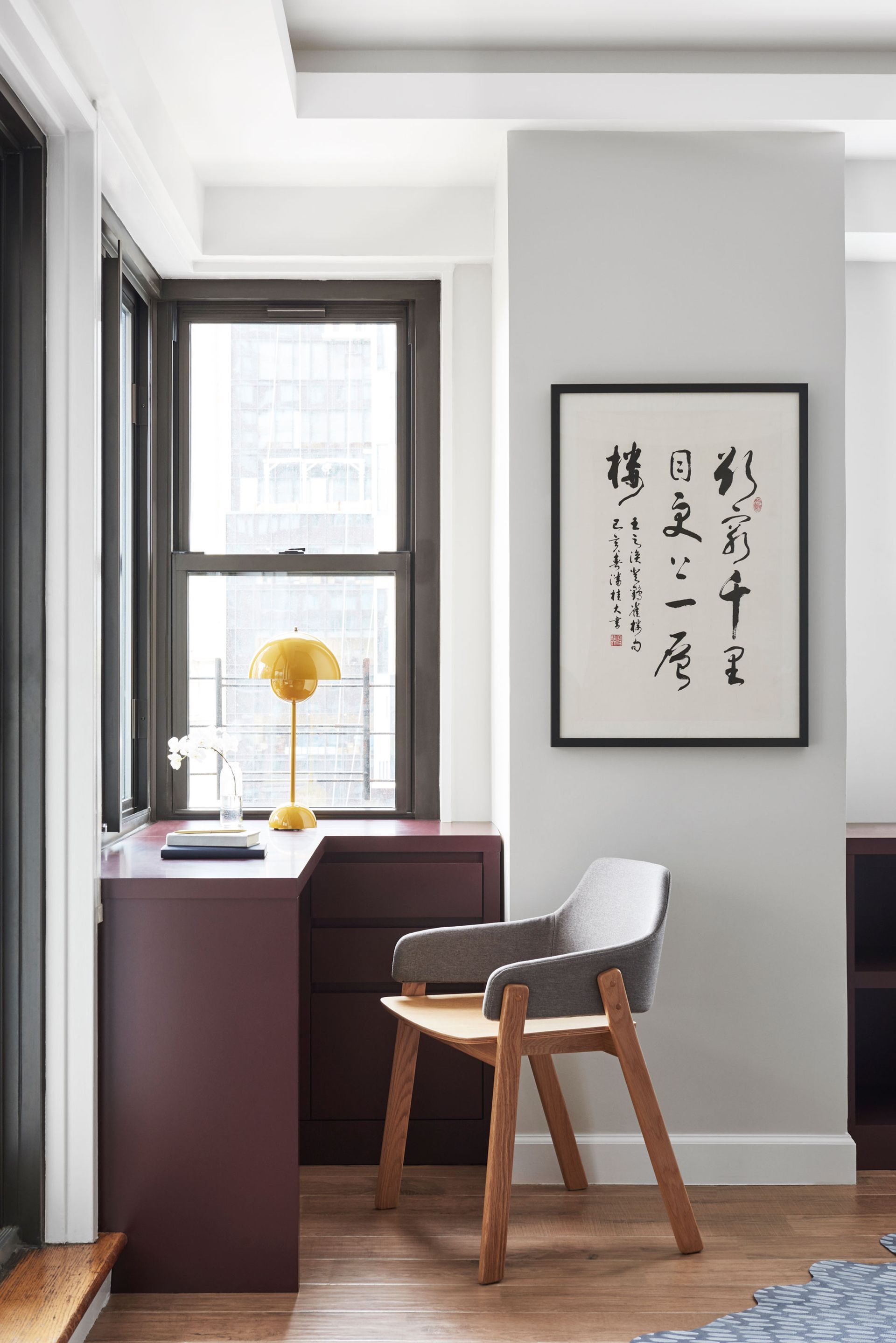 a desk in a window corner in an apartment