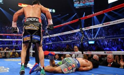 Manny Pacquiao lays face down on the mat after being knocked out in the sixth round by Juan Manuel Marquez on Dec. 8.