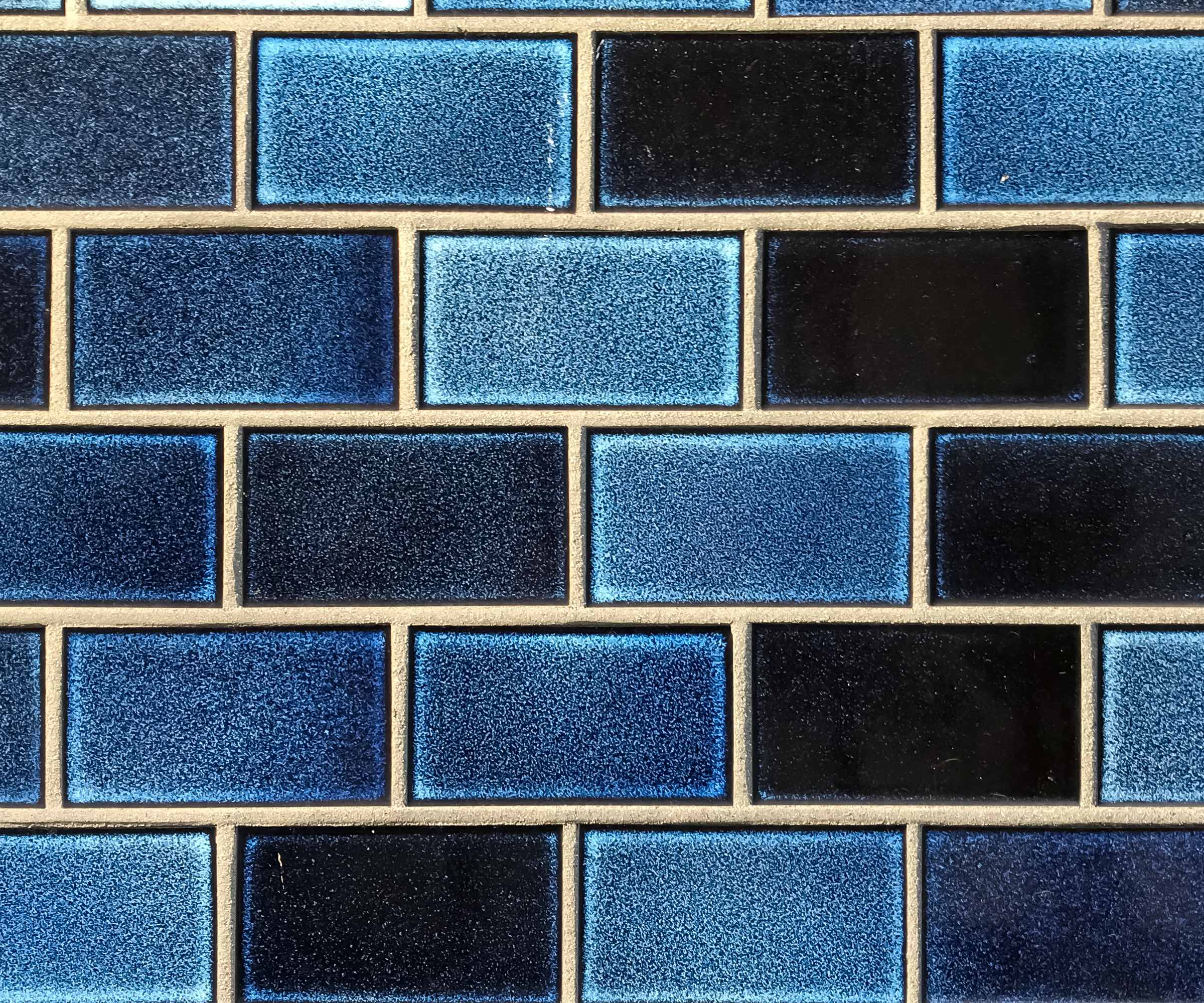 Blue rectangular tiles laid out in a half bond pattern