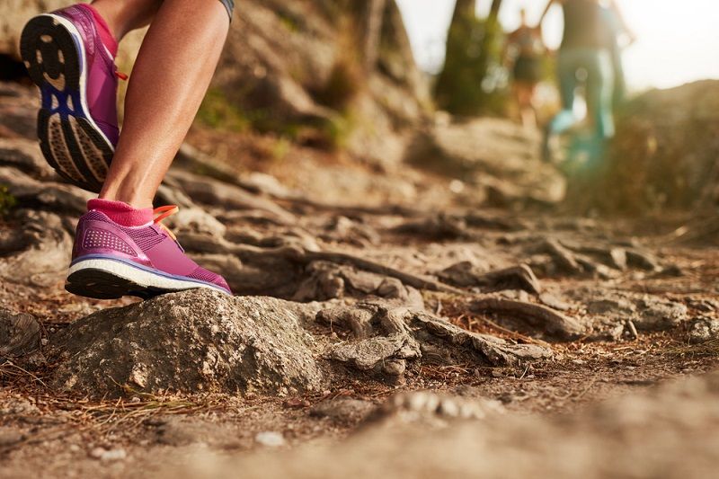 A trail with people running.