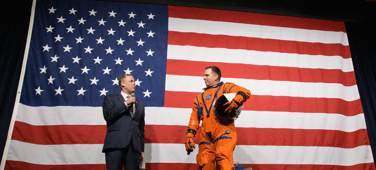 NASA Administrator Jim Bridenstine, left, speaks with Dustin Gohmert, Orion Crew Survival Systems Project Manager at NASA&rsquo;s Johnson Space Center, wearing the Orion Crew Survival System suit, about the suit, Tuesday, Oct. 15, 2019 at NASA Headquarters in Washington.