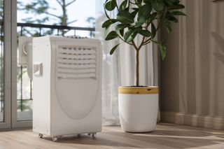 A mock up of an air conditioning unit beside a plant