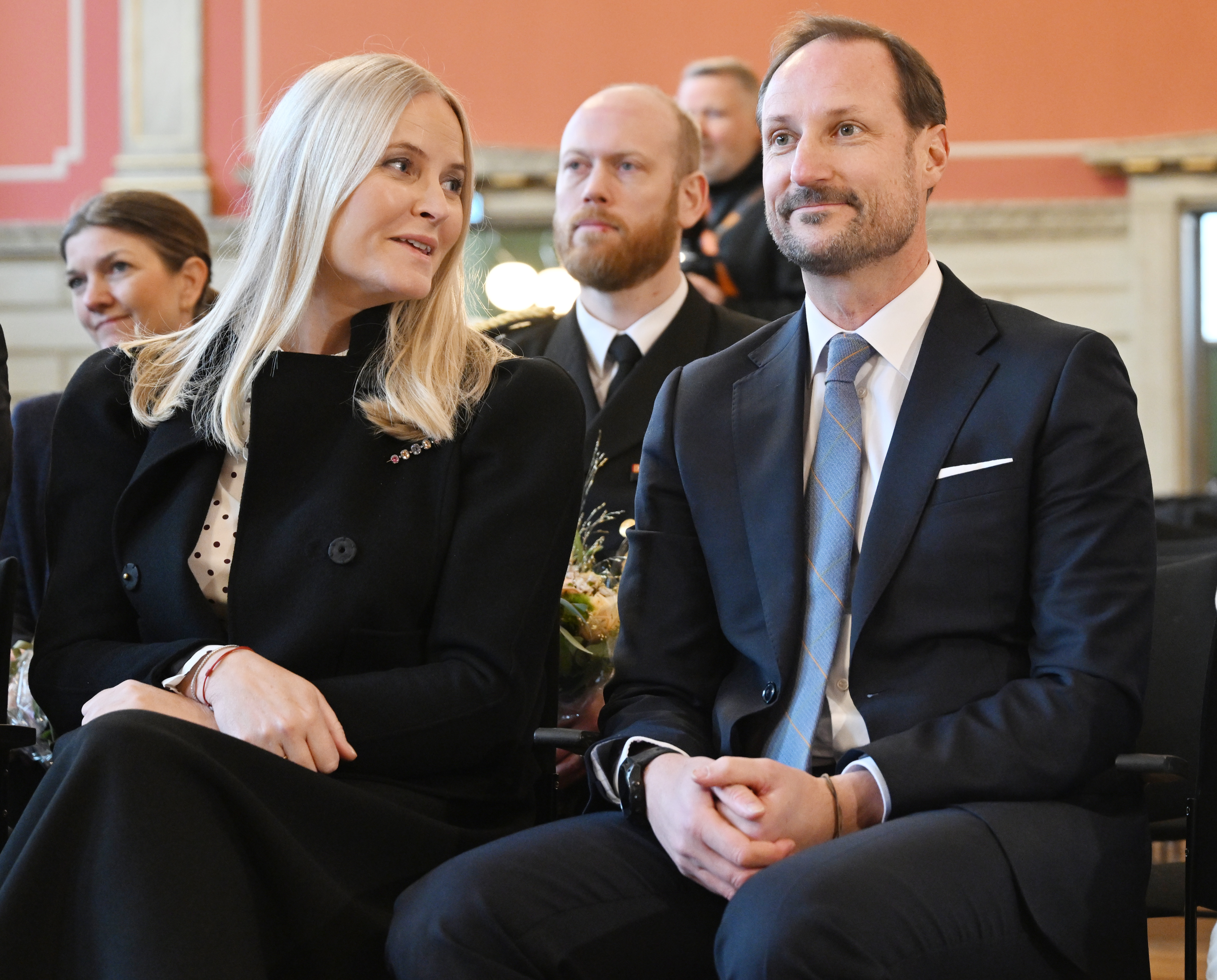 Crown Princess Mette-Marit and Crown Prince Haakon sitting next to each other in chairs