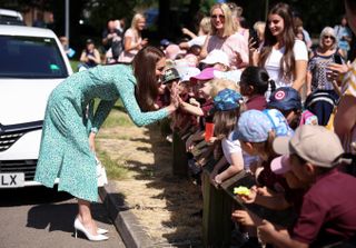 Kate Middleton interacts with children on a royal engagement